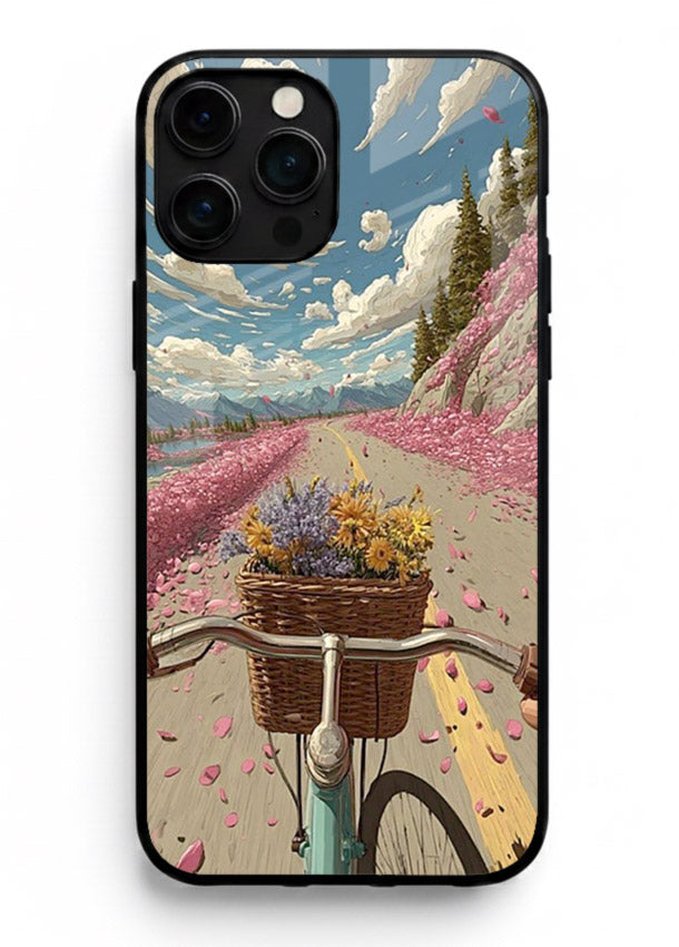 Bicycle with blossom-filled basket artwork on iphone 15 pro max glass back cover with soft scenic floral detailing.