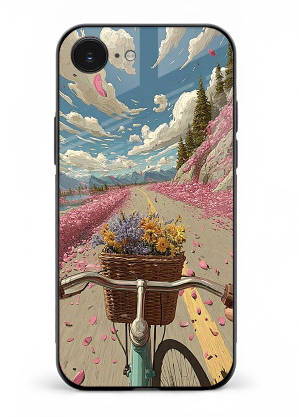 Bicycle with blossom-filled basket artwork on iphone 16e glass back cover with soft scenic floral detailing.
