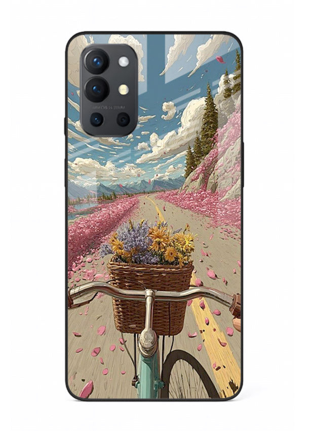 Bicycle with blossom-filled basket artwork on OnePlus 9R glass back cover with soft scenic floral detailing.