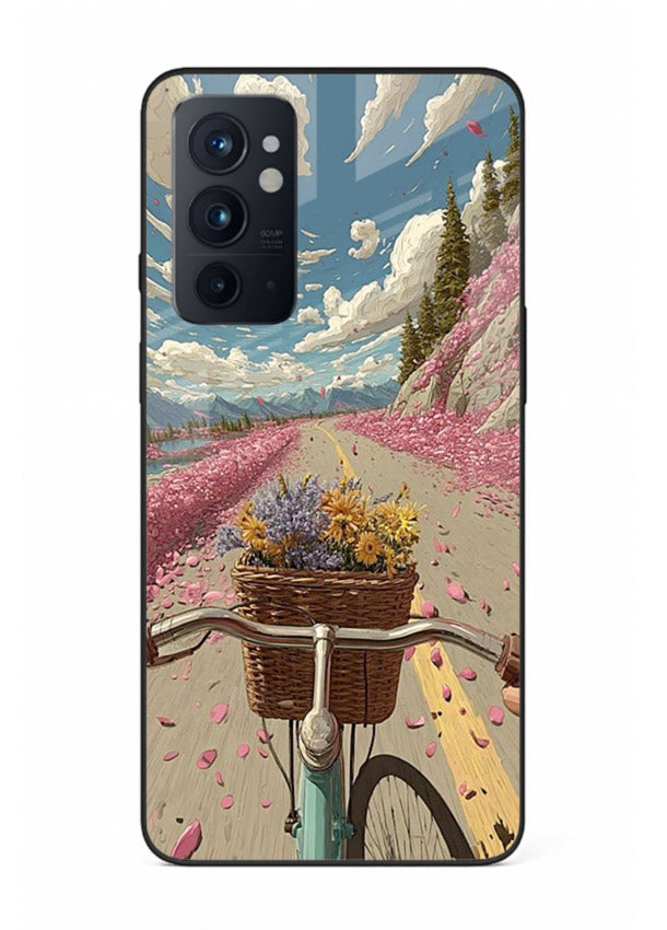 Bicycle with blossom-filled basket artwork on OnePlus 9RT glass back cover with soft scenic floral detailing.