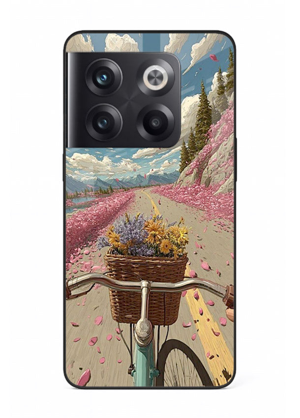 Bicycle with blossom-filled basket artwork on OnePlus 10T glass back cover with soft scenic floral detailing.
