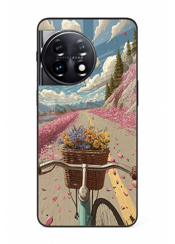 Bicycle with blossom-filled basket artwork on OnePlus 11 glass back cover with soft scenic floral detailing.