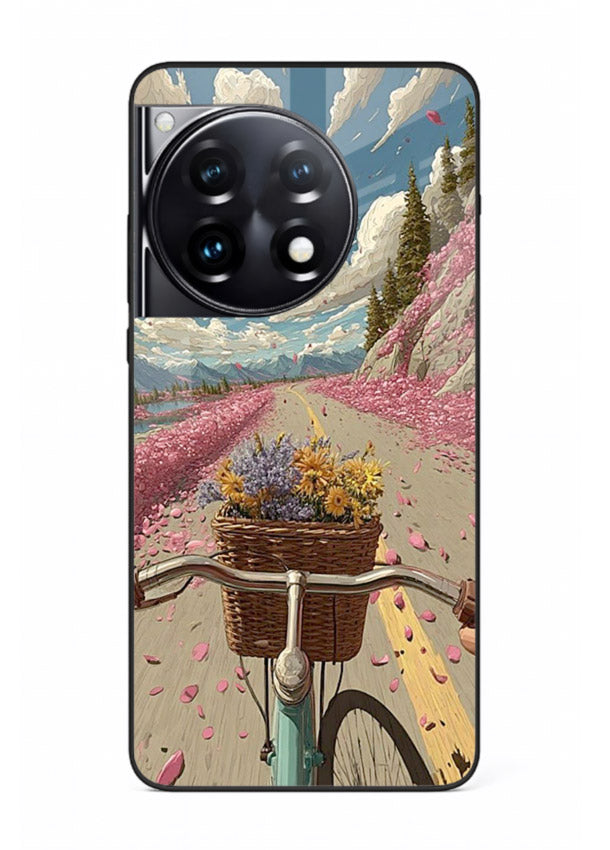 Bicycle with blossom-filled basket artwork on OnePlus 12R glass back cover with soft scenic floral detailing.