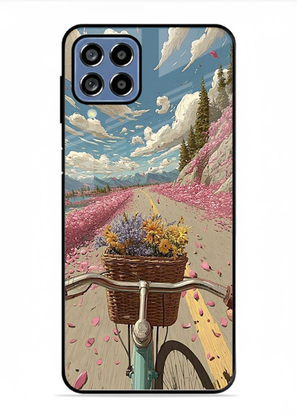 Bicycle with blossom-filled basket artwork on Samsung F12 5G glass back cover with soft scenic floral detailing.