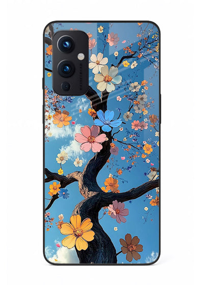 Blue blossom branch artwork on OnePlus 9 Pro glass back cover with cool botanical tones.