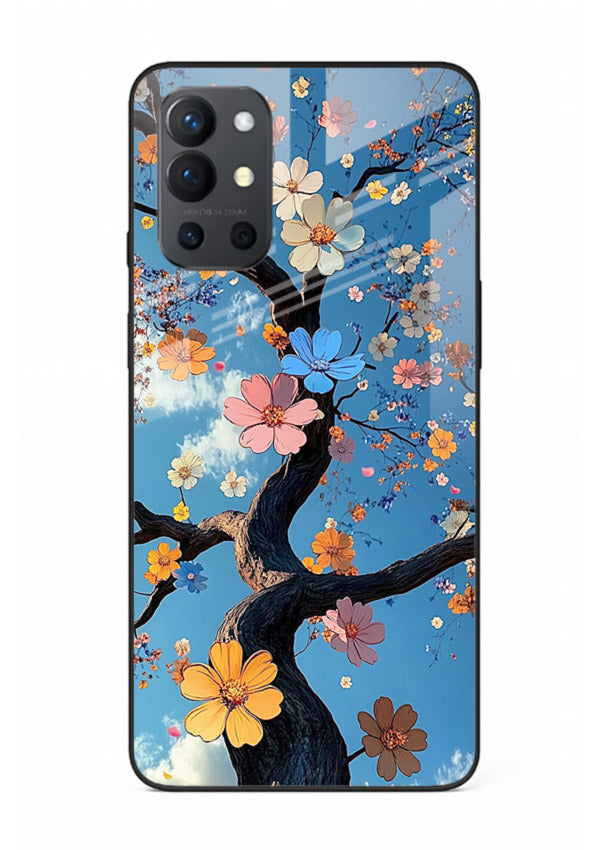 Blue blossom branch artwork on OnePlus 9R glass back cover with cool botanical tones.