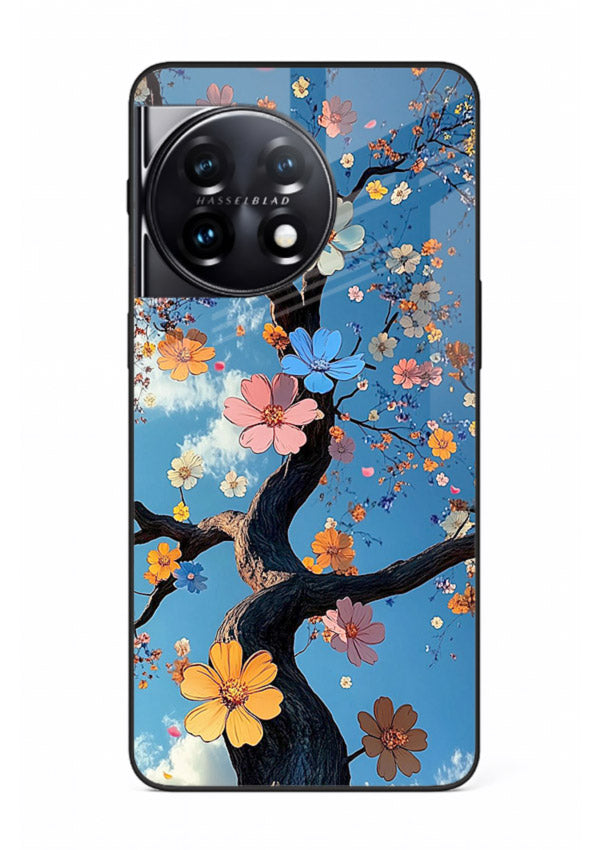 Blue blossom branch artwork on OnePlus 11R glass back cover with cool botanical tones.
