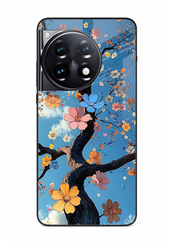 Blue blossom branch artwork on OnePlus 12R glass back cover with cool botanical tones.