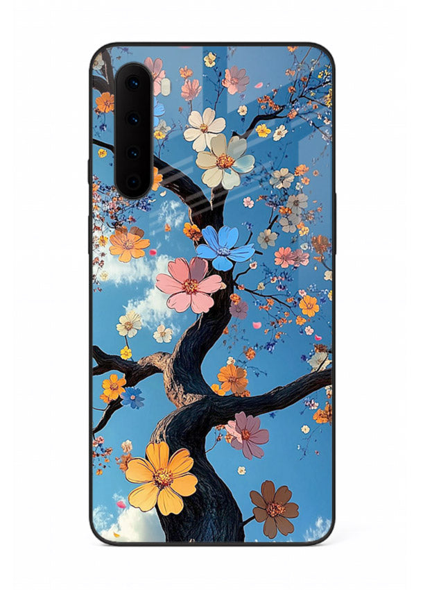 Blue blossom branch artwork on OnePlus Nord glass back cover with cool botanical tones.