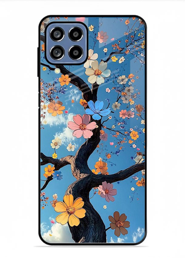 Blue blossom branch artwork on Samsung F12 5G glass back cover with cool botanical tones.