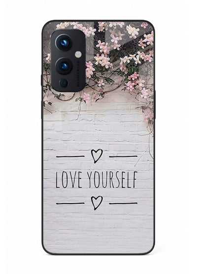 Floral self-love message printed on OnePlus 9 Pro glass back cover with gentle pastel tones.