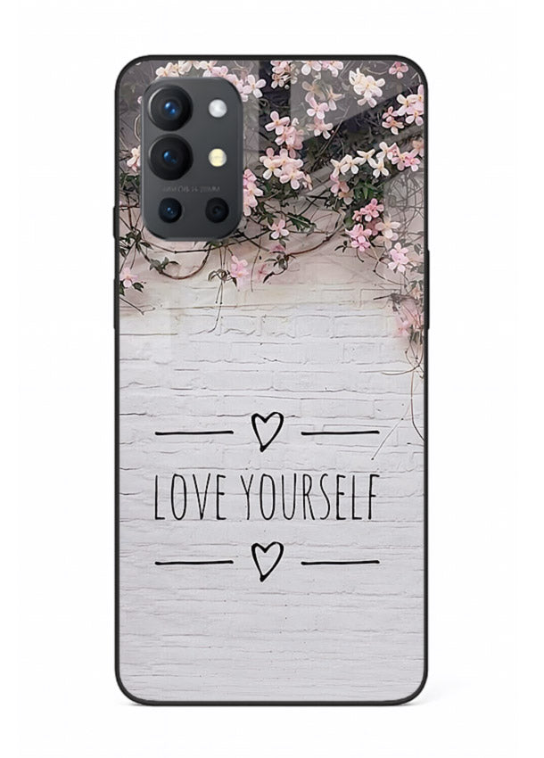 Floral self-love message printed on OnePlus 9R glass back cover with gentle pastel tones.