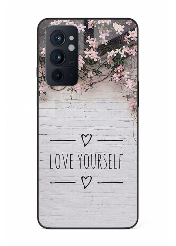Floral self-love message printed on OnePlus 9RT glass back cover with gentle pastel tones.