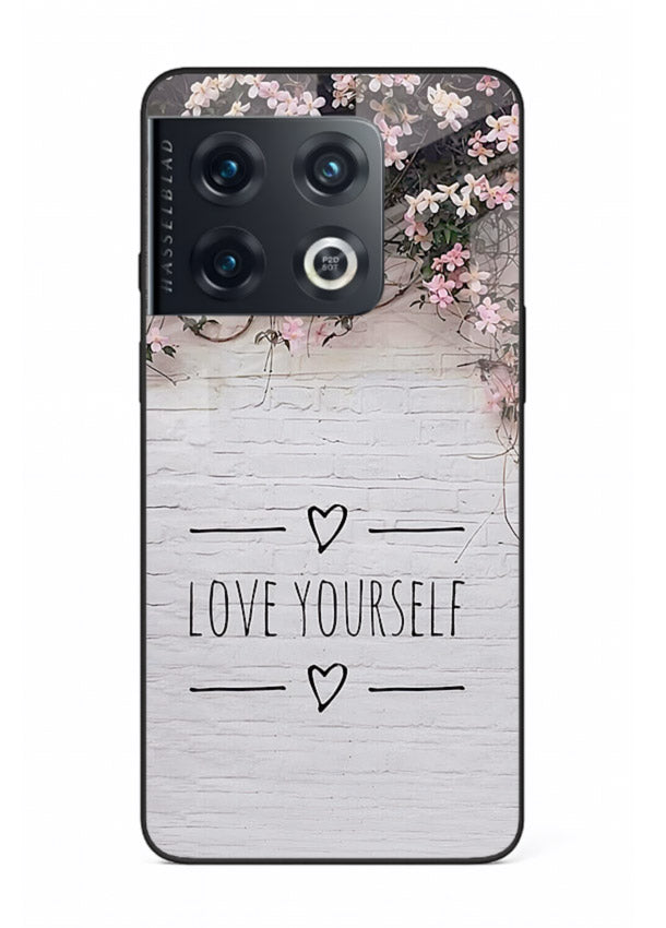 Floral self-love message printed on OnePlus 10 Pro glass back cover with gentle pastel tones.