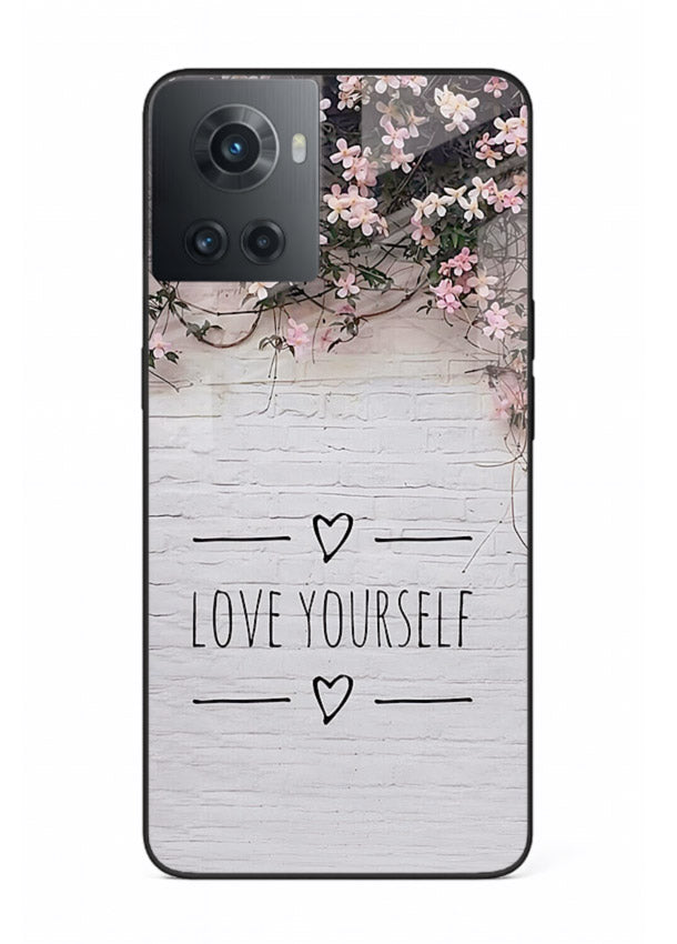 Floral self-love message printed on OnePlus 10R glass back cover with gentle pastel tones.