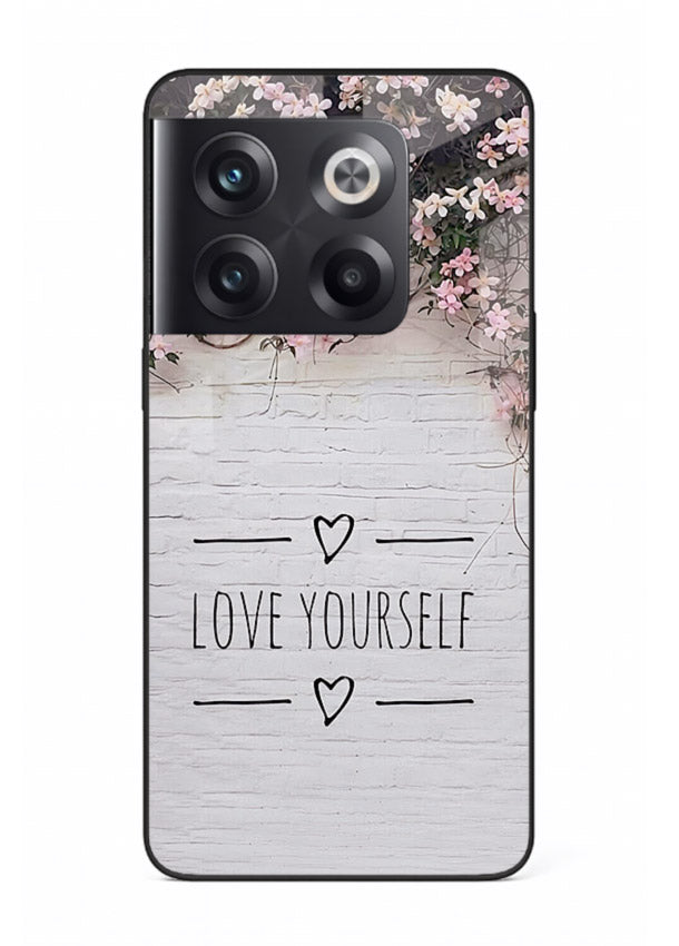 Floral self-love message printed on OnePlus 10T glass back cover with gentle pastel tones.