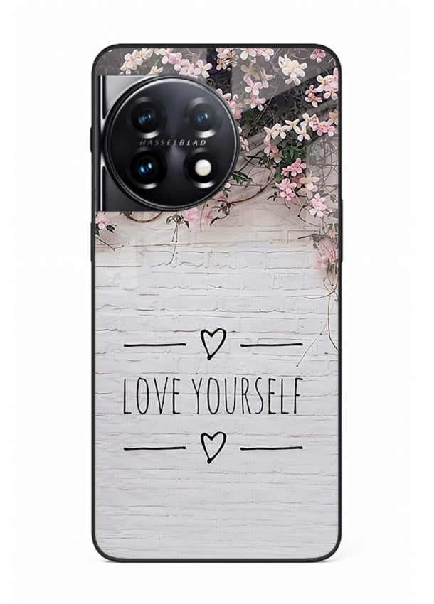 Floral self-love message printed on OnePlus 11 glass back cover with gentle pastel tones.