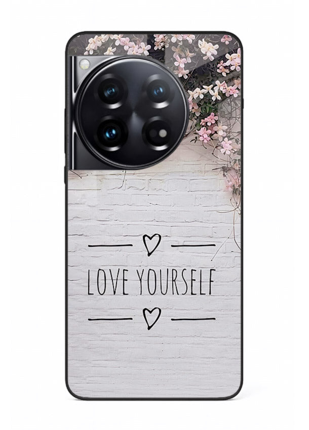 Floral self-love message printed on OnePlus 12 glass back cover with gentle pastel tones.