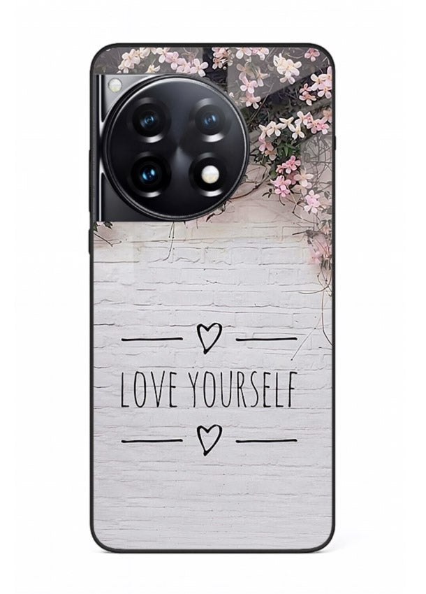 Floral self-love message printed on OnePlus 12R glass back cover with gentle pastel tones.