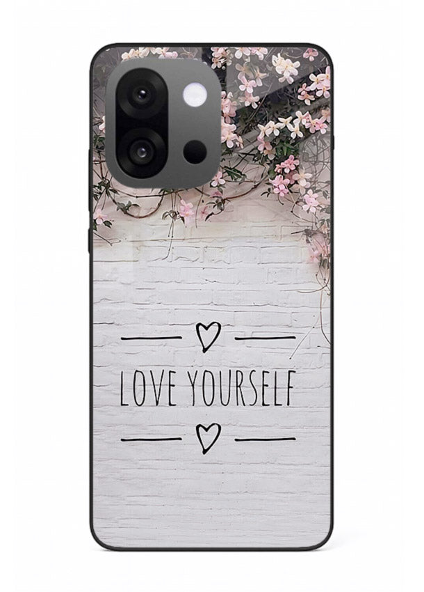 Floral self-love message printed on OnePlus 13s glass back cover with gentle pastel tones.
