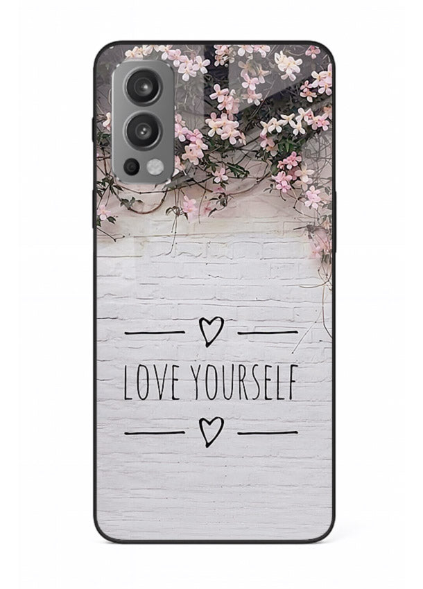 Floral self-love message printed on OnePlus Nord 2 glass back cover with gentle pastel tones.