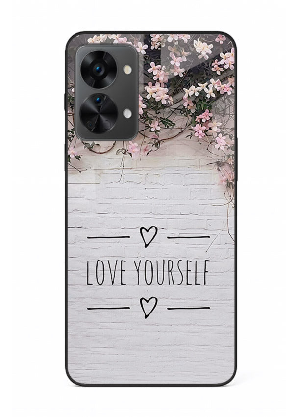 Floral self-love message printed on OnePlus Nord 2T glass back cover with gentle pastel tones.
