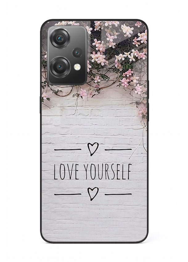 Floral self-love message printed on OnePlus Nord CE2 Lite 5G glass back cover with gentle pastel tones.