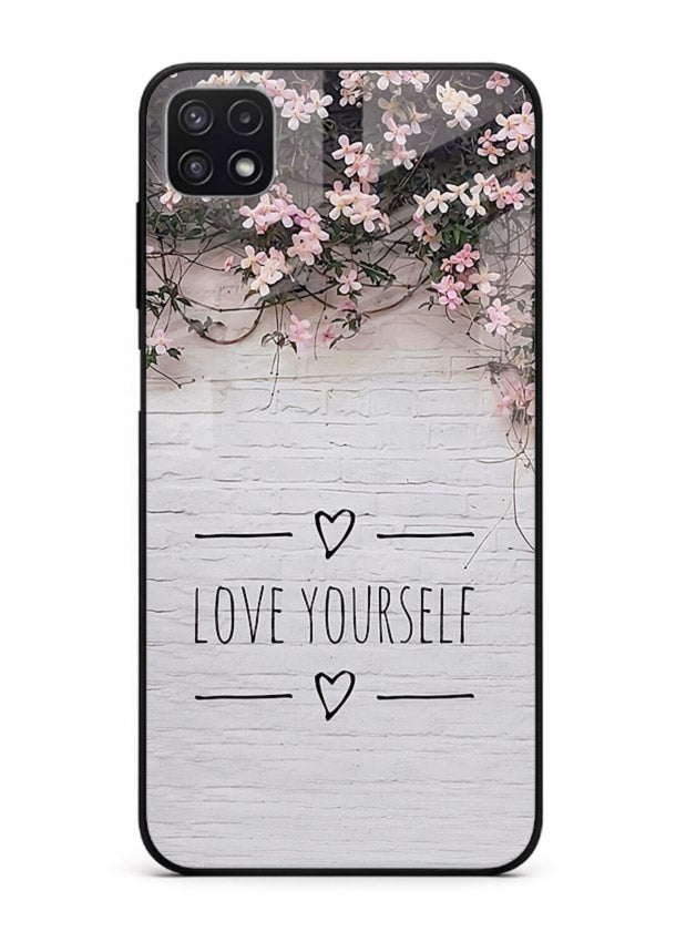 Floral self-love message printed on Samsung F42 5G glass back cover with gentle pastel tones.