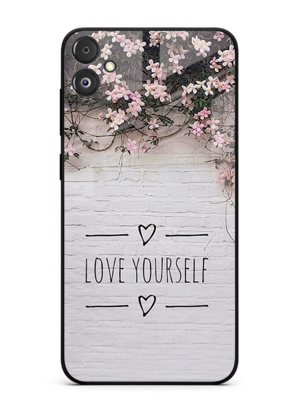 Floral self-love message printed on Samsung F05 5G glass back cover with gentle pastel tones.