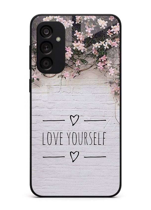 Floral self-love message printed on Samsung M14 5G glass back cover with gentle pastel tones.