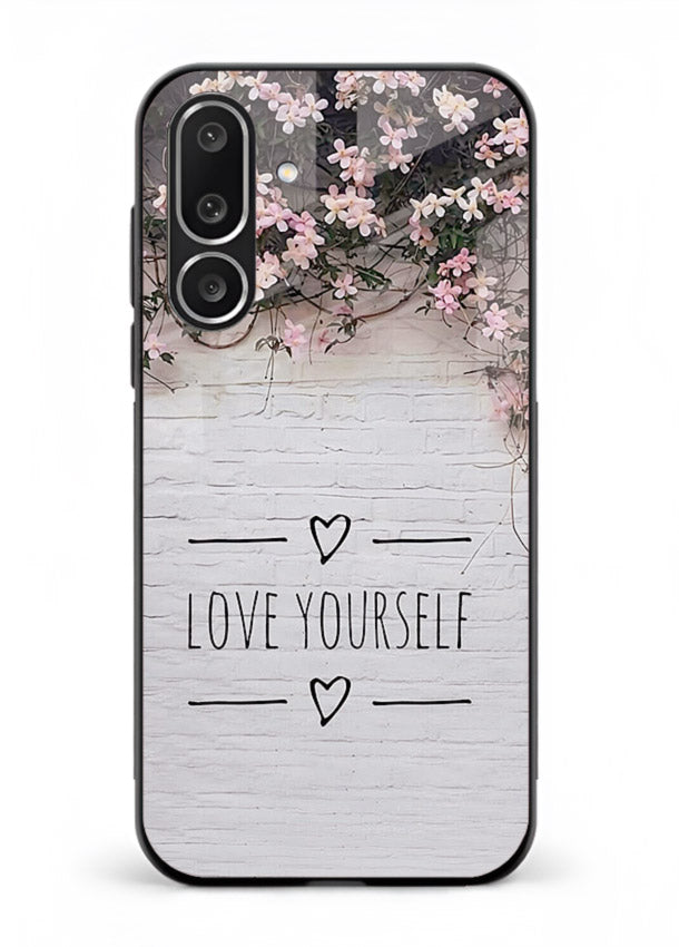 Floral self-love message printed on Samsung M36 5G glass back cover with gentle pastel tones.