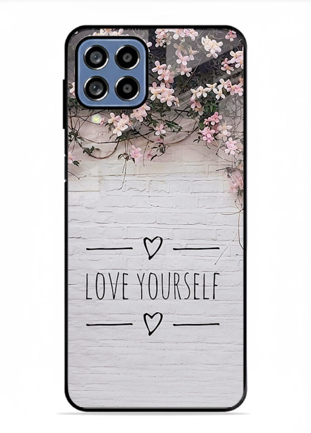 Floral self-love message printed on Samsung F22 4G glass back cover with gentle pastel tones.