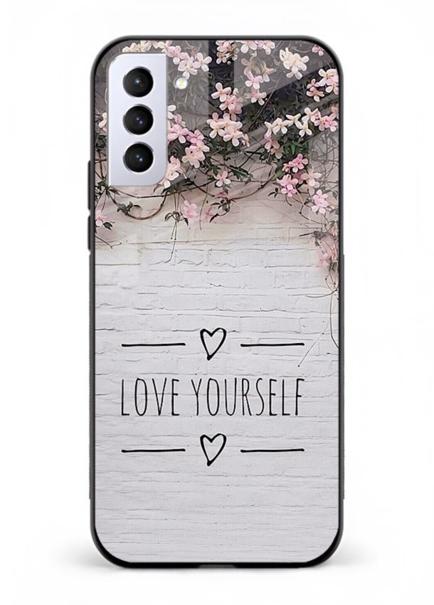 Floral self-love message printed on Samsung S21 FE glass back cover with gentle pastel tones.