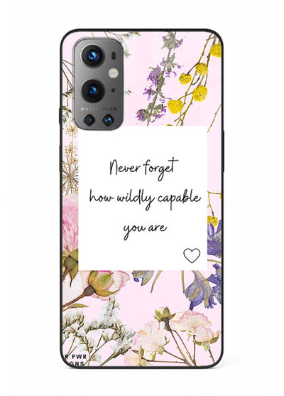 Floral-bordered motivational message printed on OnePlus 9 glass back cover with soft tones.