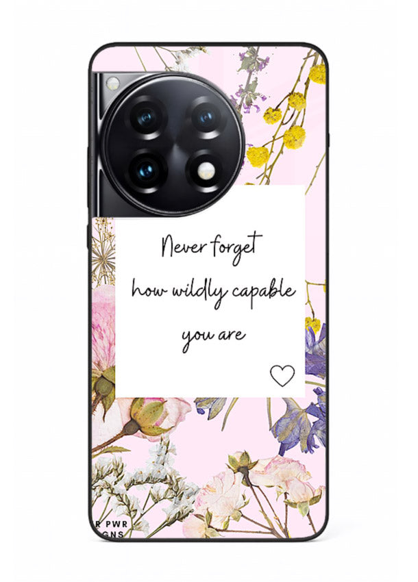 Floral-bordered motivational message printed on OnePlus 12R glass back cover with soft tones.