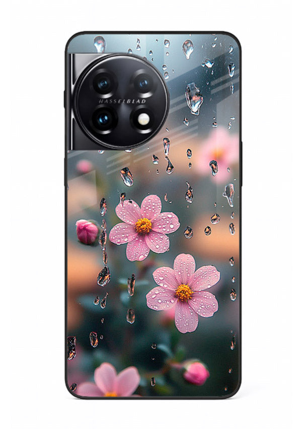 Raindrop cherry blossom artwork on OnePlus 11R glass back cover with soft pastel tones.