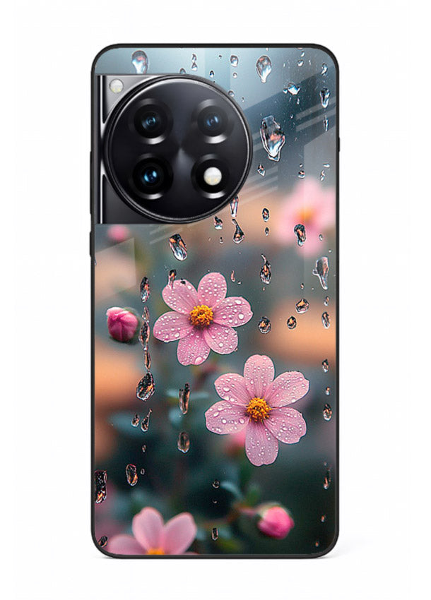 Raindrop cherry blossom artwork on OnePlus 12R glass back cover with soft pastel tones.