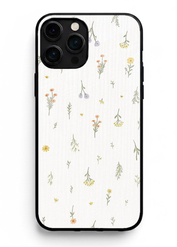 Tiny floral pattern artwork on iphone 13 pro max glass back cover with scattered blooms.