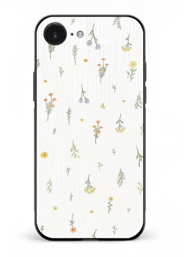Tiny floral pattern artwork on iphone 16e glass back cover with scattered blooms.