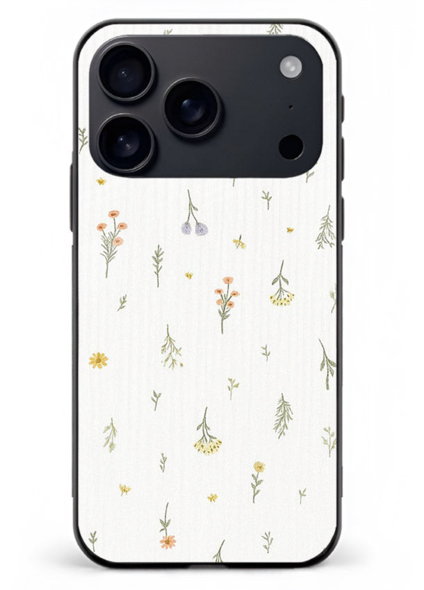 Tiny floral pattern artwork on iphone 17 pro max glass back cover with scattered blooms.