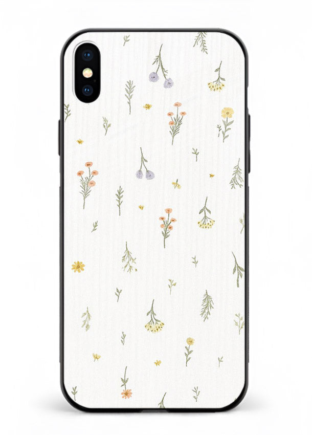Tiny floral pattern artwork on iphone xs max glass back cover with scattered blooms.