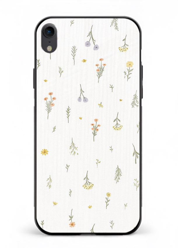 Tiny floral pattern artwork on iphone xr glass back cover with scattered blooms.