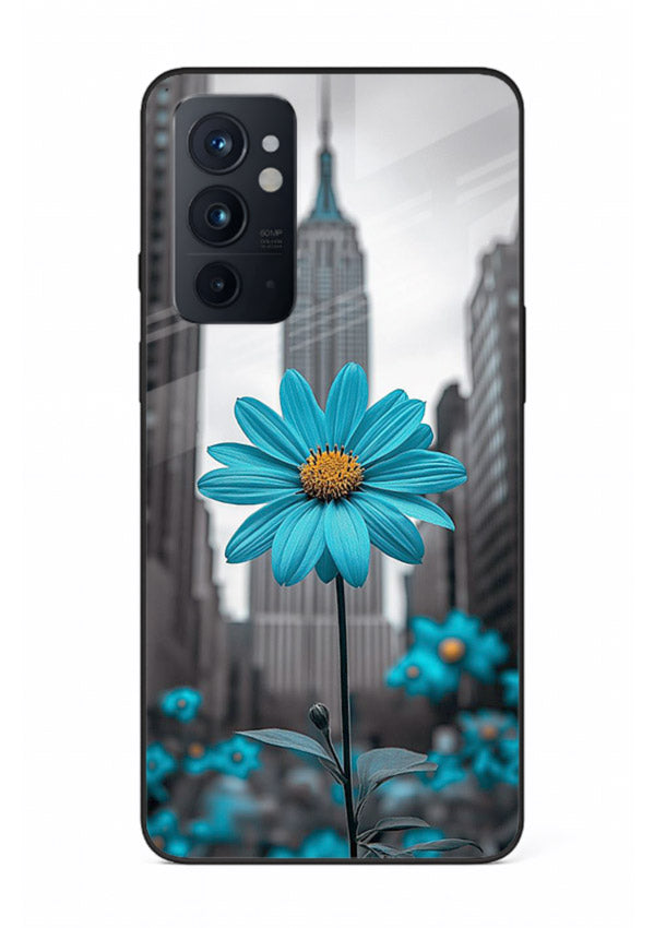 Blue daisy artwork on OnePlus 9RT glass back cover with bold modern floral styling.